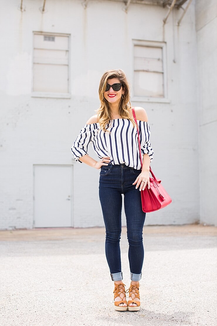 rolled jeans + off the shoulder top + wedges + red bag + prada sunglasses