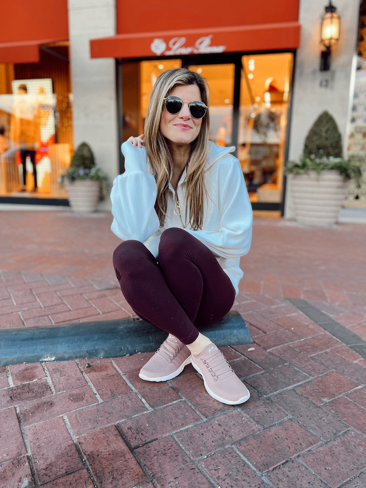 Brighton Butler wearing Varley pullover with maroon lulu aligns and APL's