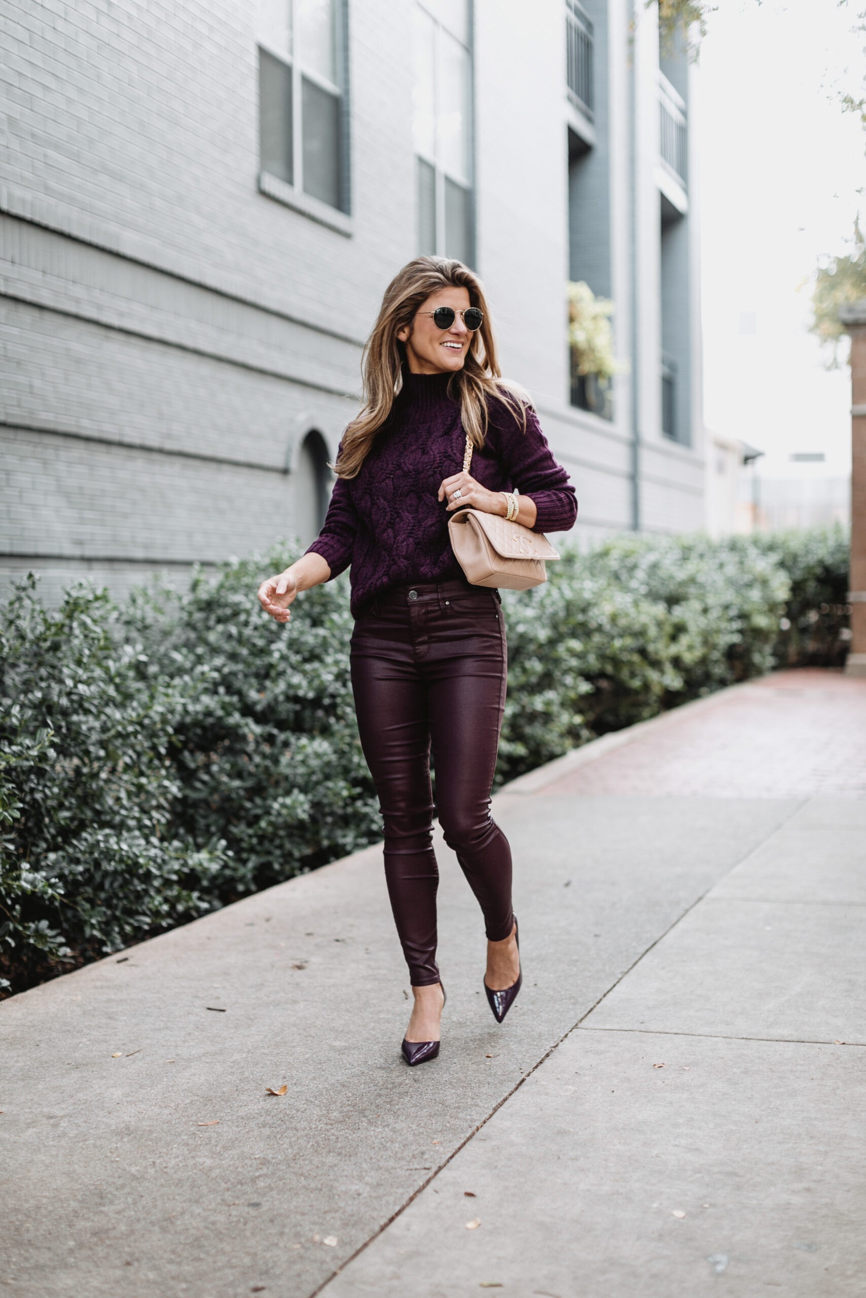 Brighton Butler wearing White House Black Market purple patent pants with purple sweater and pumps