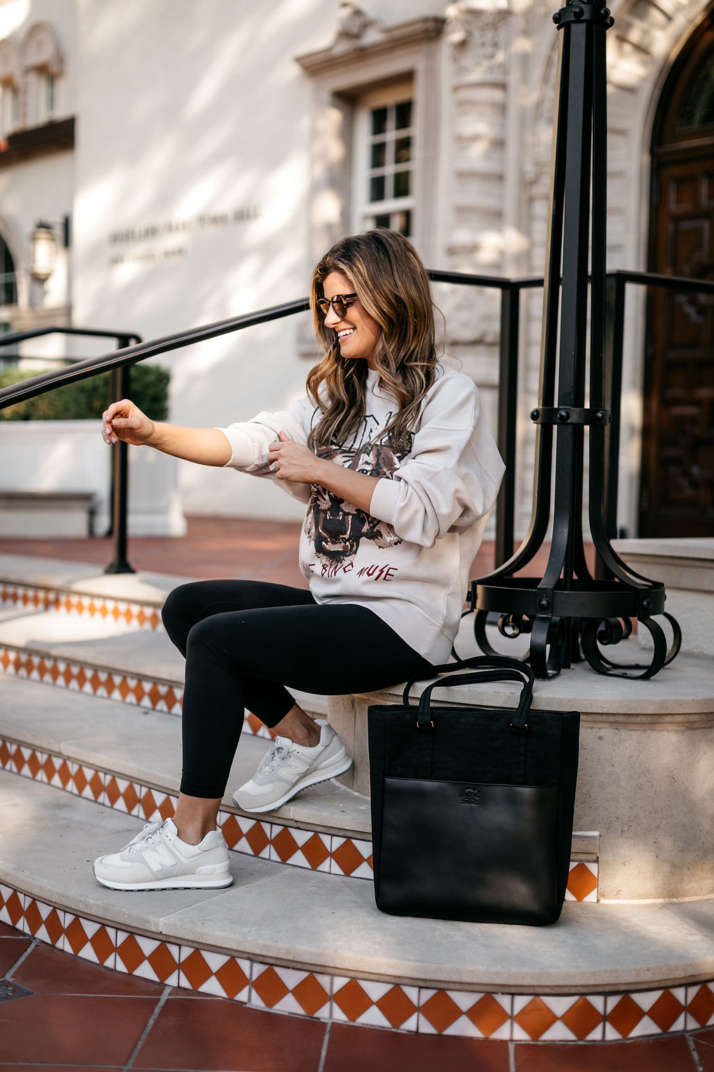 athleisure outfit graphic sweatshirt, black leggings, new balance sneakers, computer bag 15