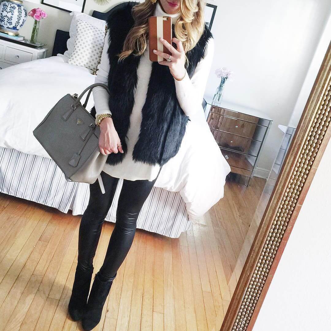 black faux fur vest, cream turtleneck sweater, leather leggings, brown booties, winter date night outfit brightonkeller