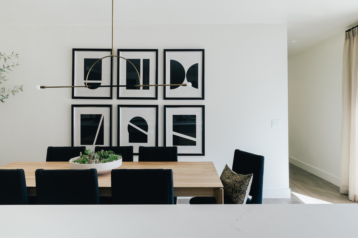 brighton butler denver home dining room black and white art, black chairs, oak dining table