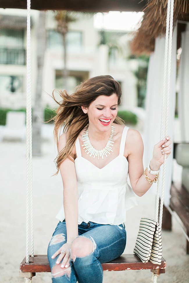 brightontheday sitting on swing wearing white peplum top kendra scott statement necklac