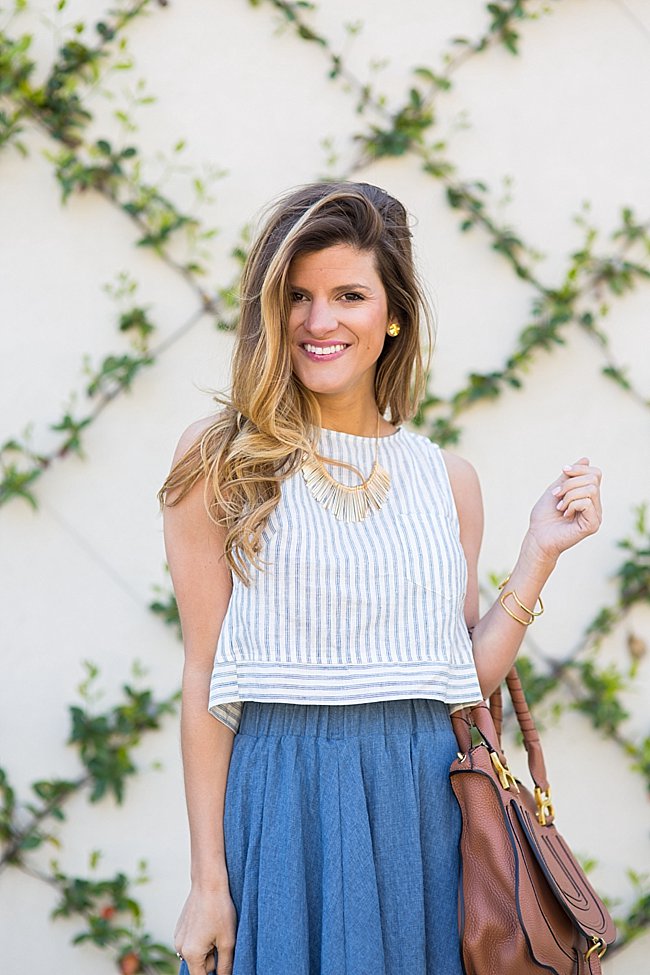 brightontheday wearing flared crop top with high-waisted skirt, statement necklace and gold stud earrings