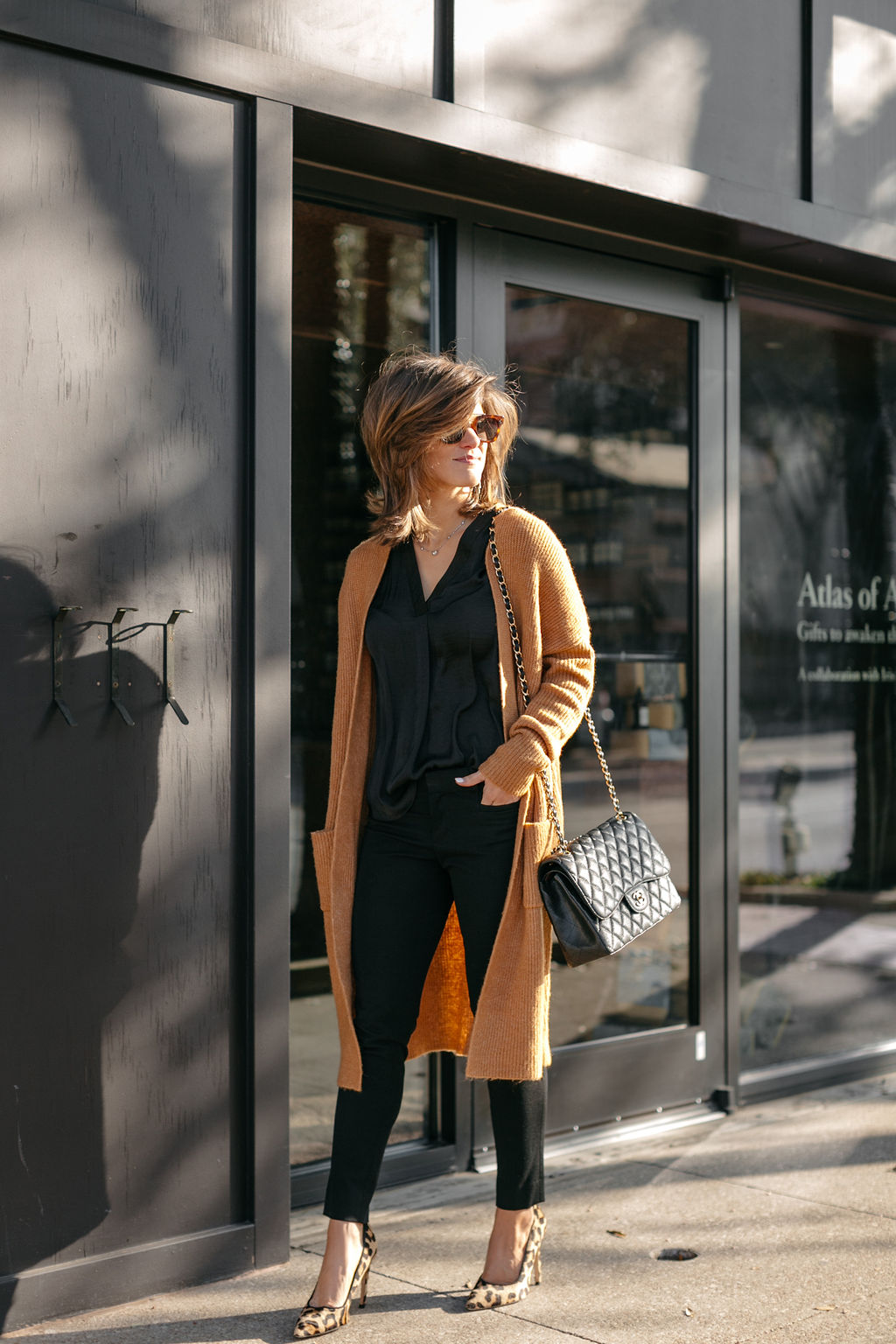 business casual all black outfit long cardigan leopard pumps