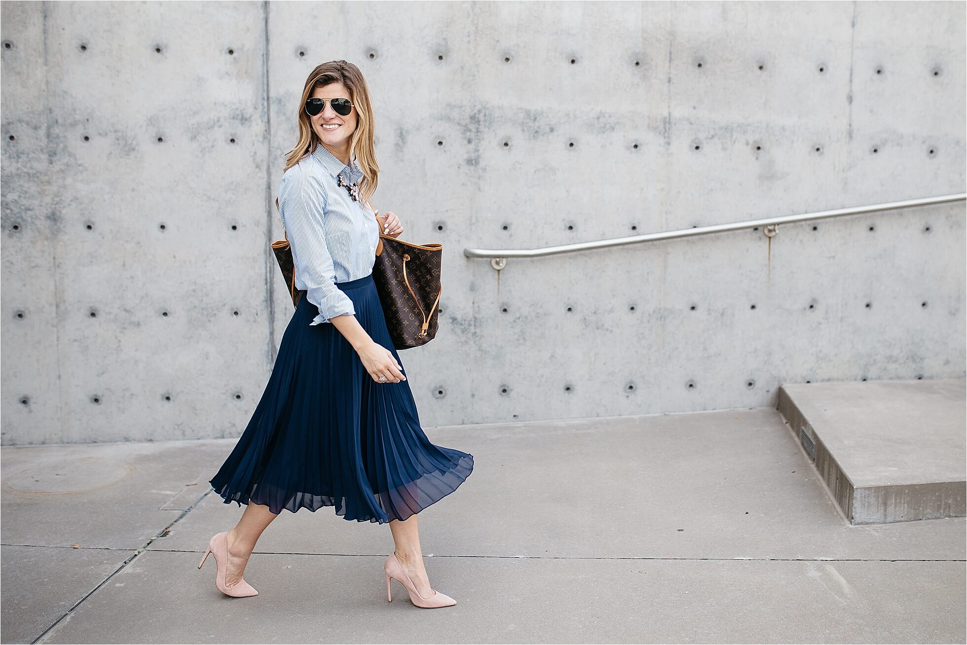 business casual outfit - pleated midi skirt, striped button up oxford, louis vuitton neverfull tote, blush pink pumps, statement necklace