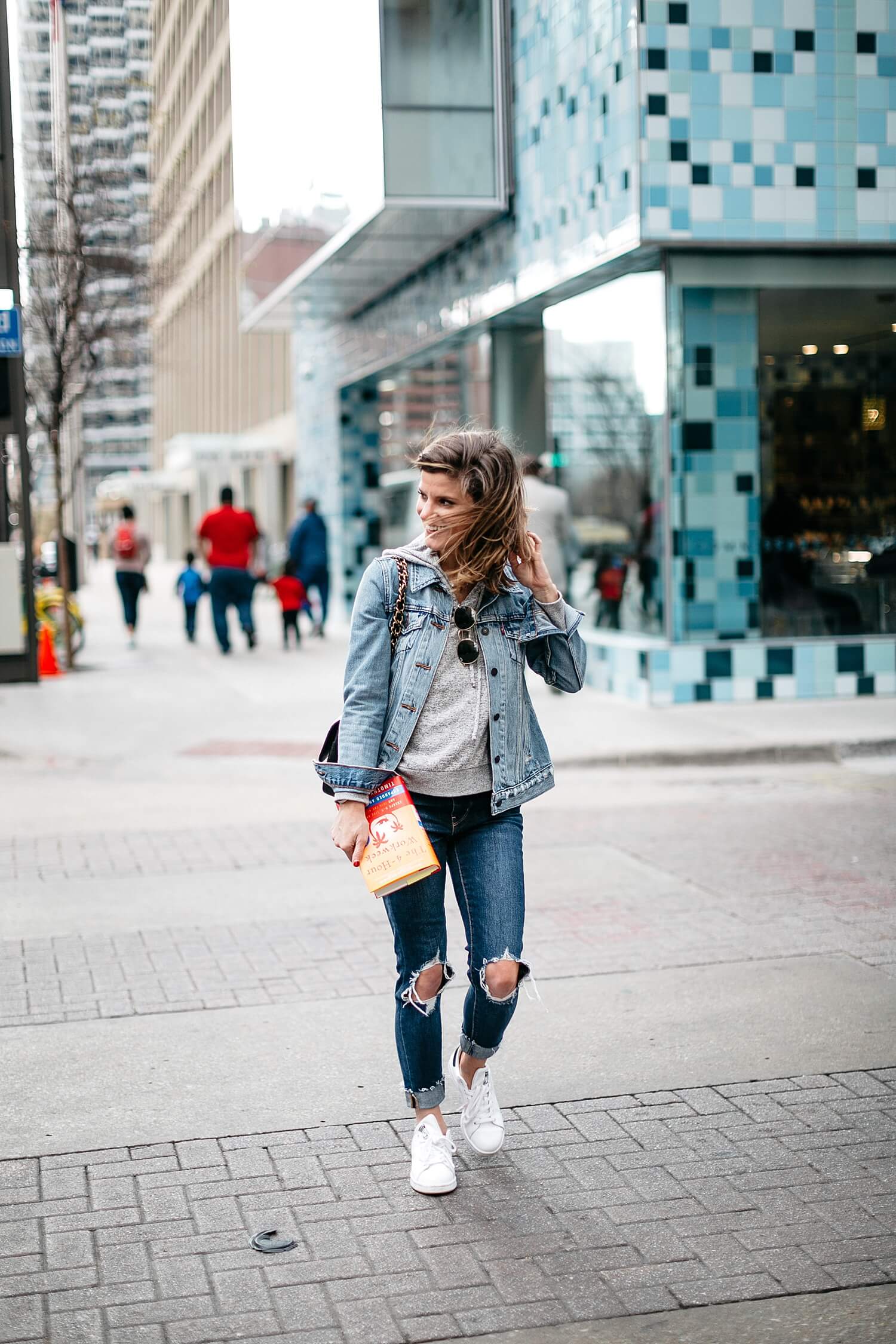 jean jacket with jeans and adidas sneakers