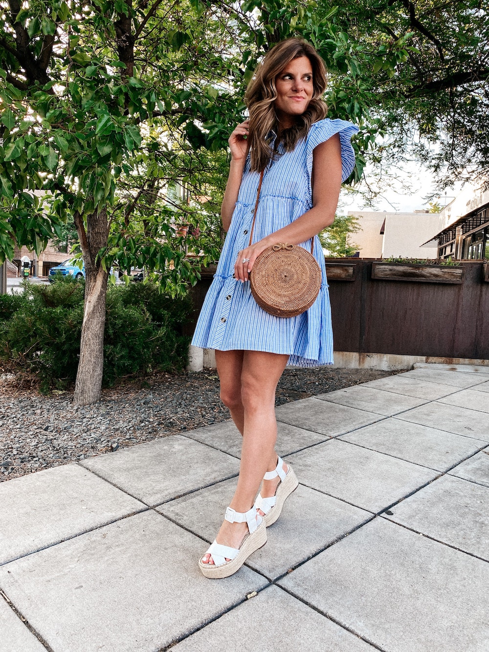 brighton butler wearing free people blue check swing dress with white platform sandals, fourth of July outfit idea