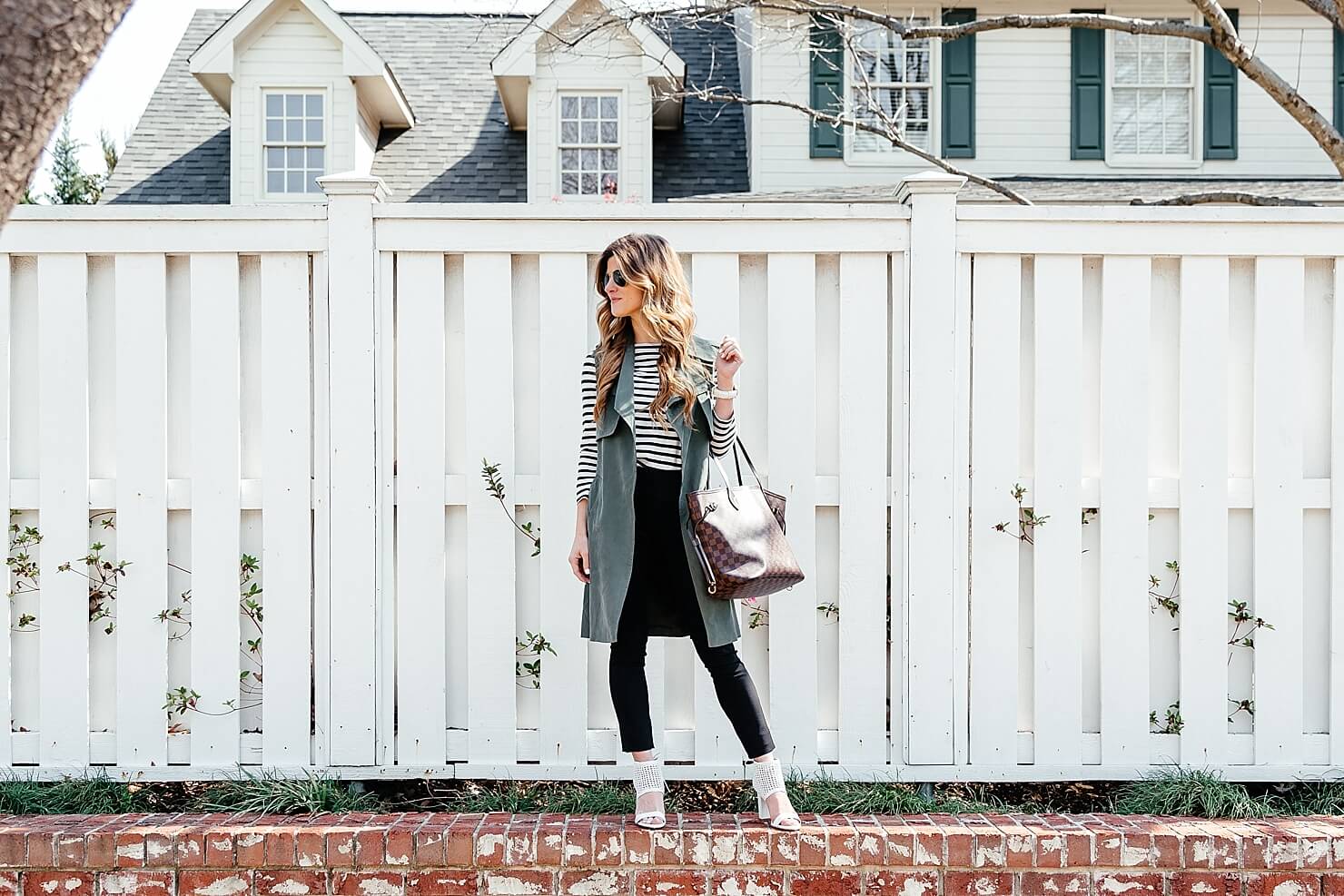 green trench vest, striped tee, black pants 30