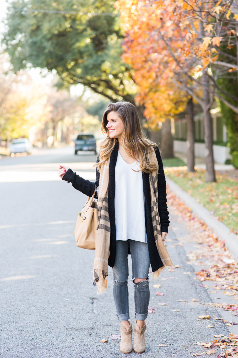 ivory sweater untucked, long black cardigan, neutral print scarf, tan booties, grey distressed denim