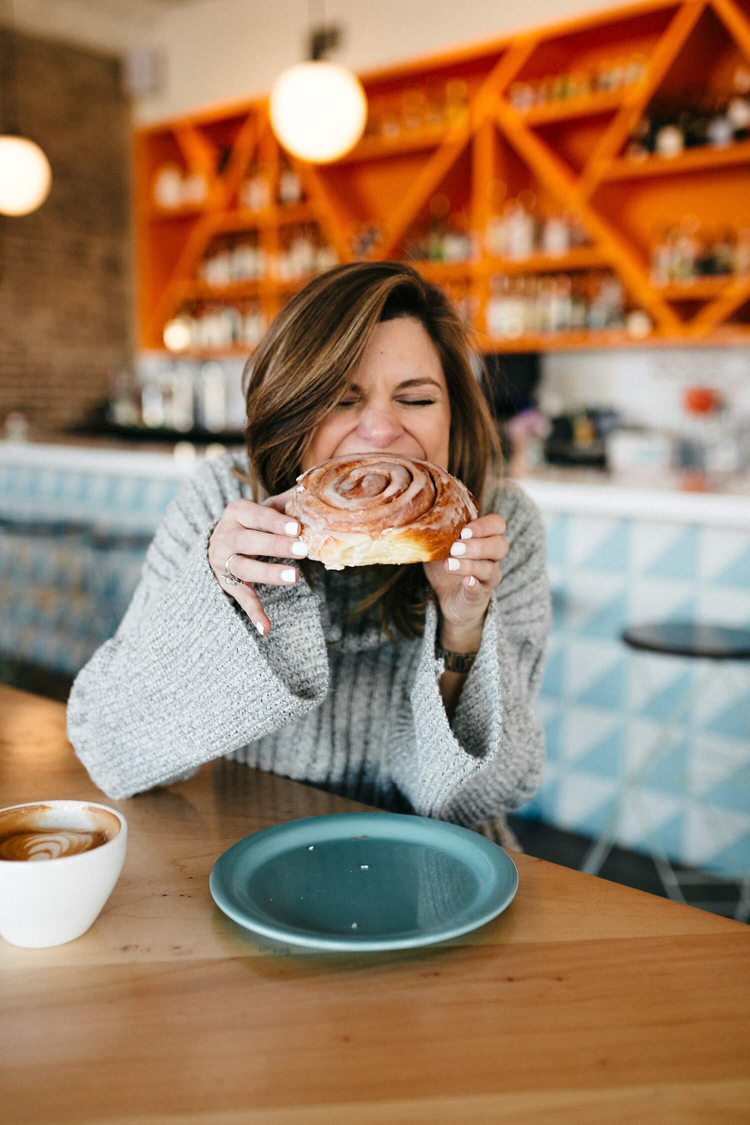 brighton keller eating cinnamon roll at halcyon coffee Dallas TX