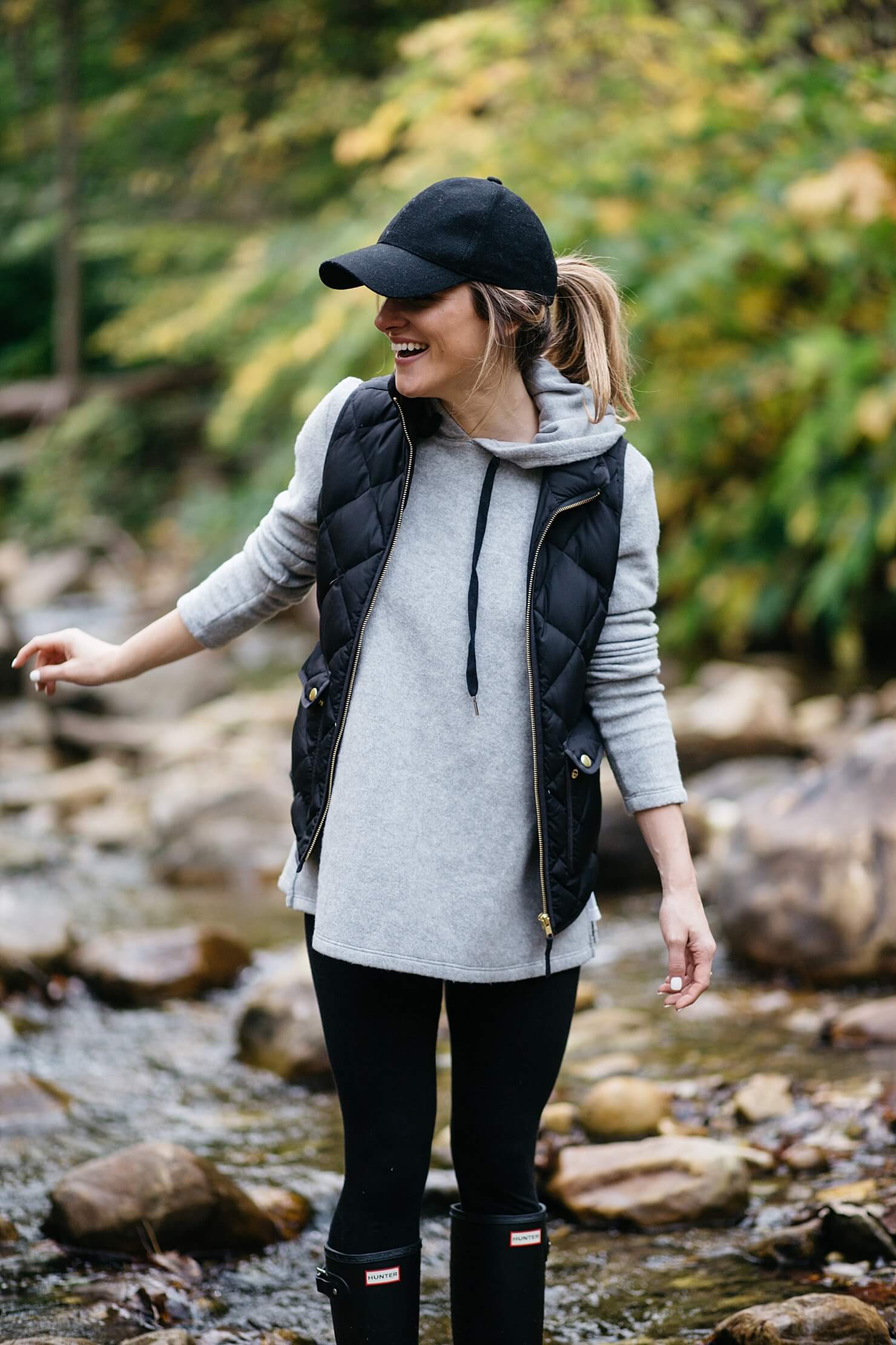 hunter boots outfit with a baseball cap and vest 