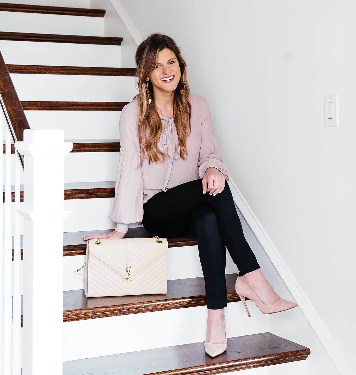 brighton keller home wearing blush shirt and black pants with pumps 