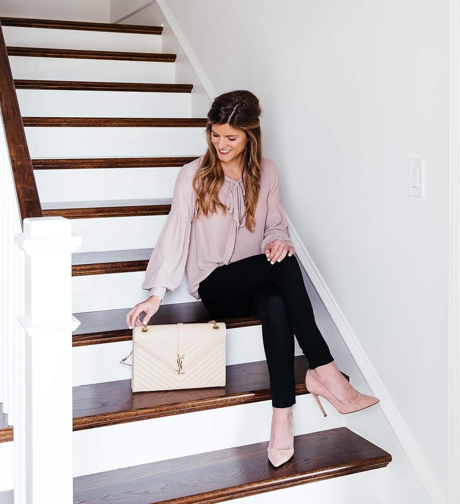 brighton keller home wearing blush shirt and black pants with pumps