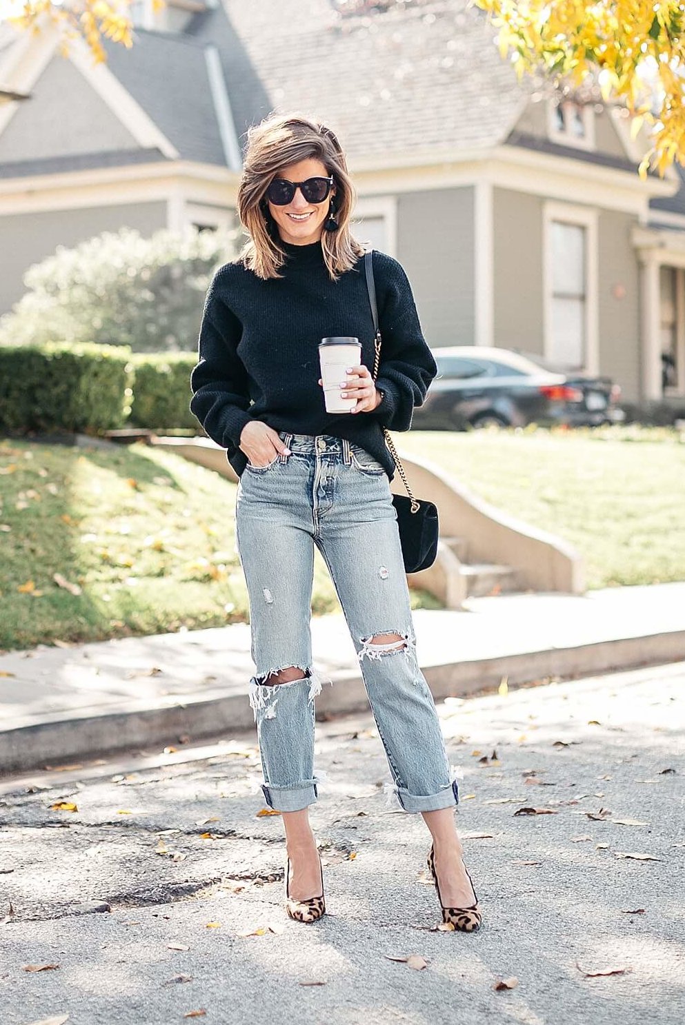 black sweater, distressed levi jeans, leopard pumps and gucci cross body