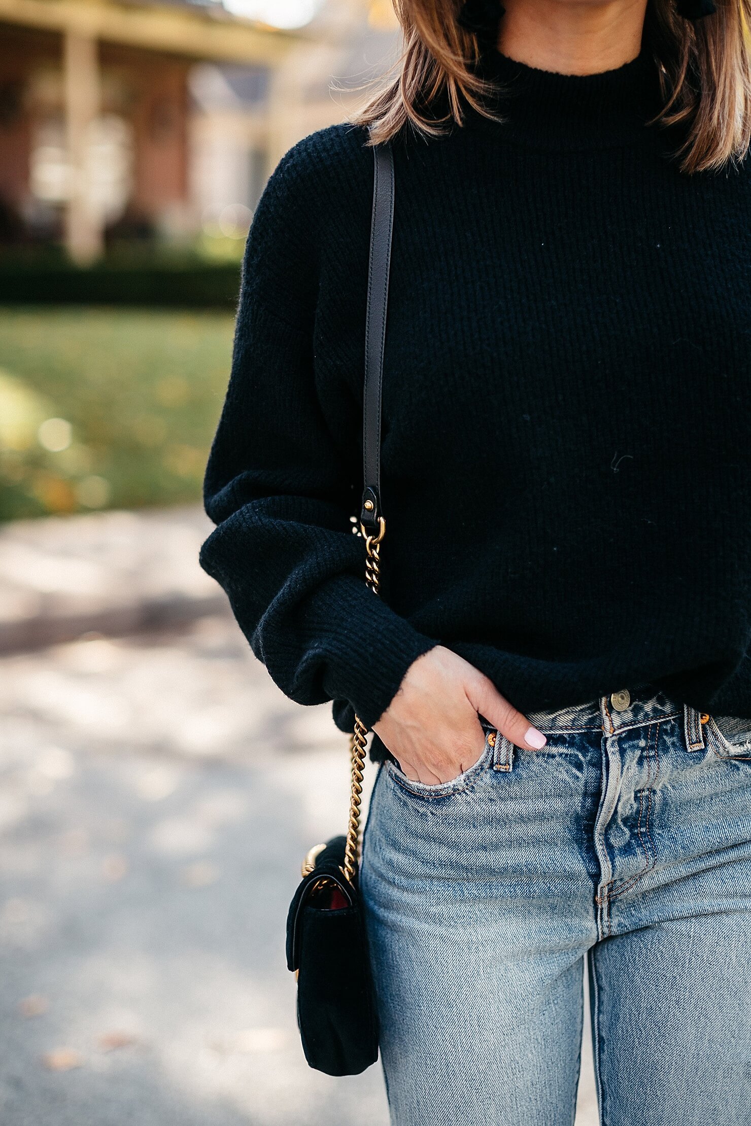 black sweater, distressed levi jeans, leopard pumps and gucci cross body 