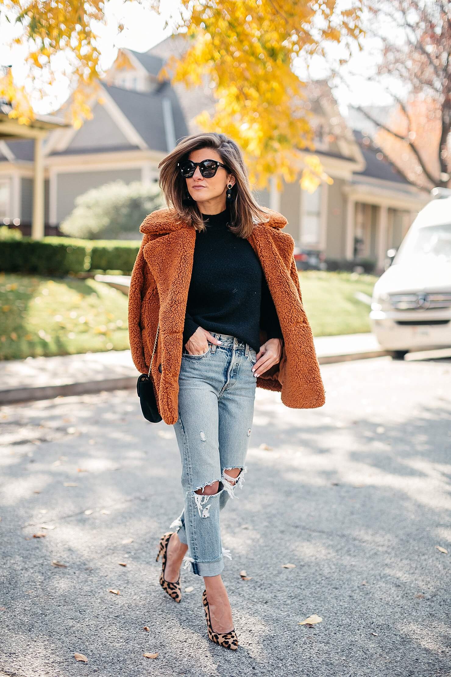 orange teddy coat, black sweater, distressed levi jeans, leopard pumps and gucci cross body