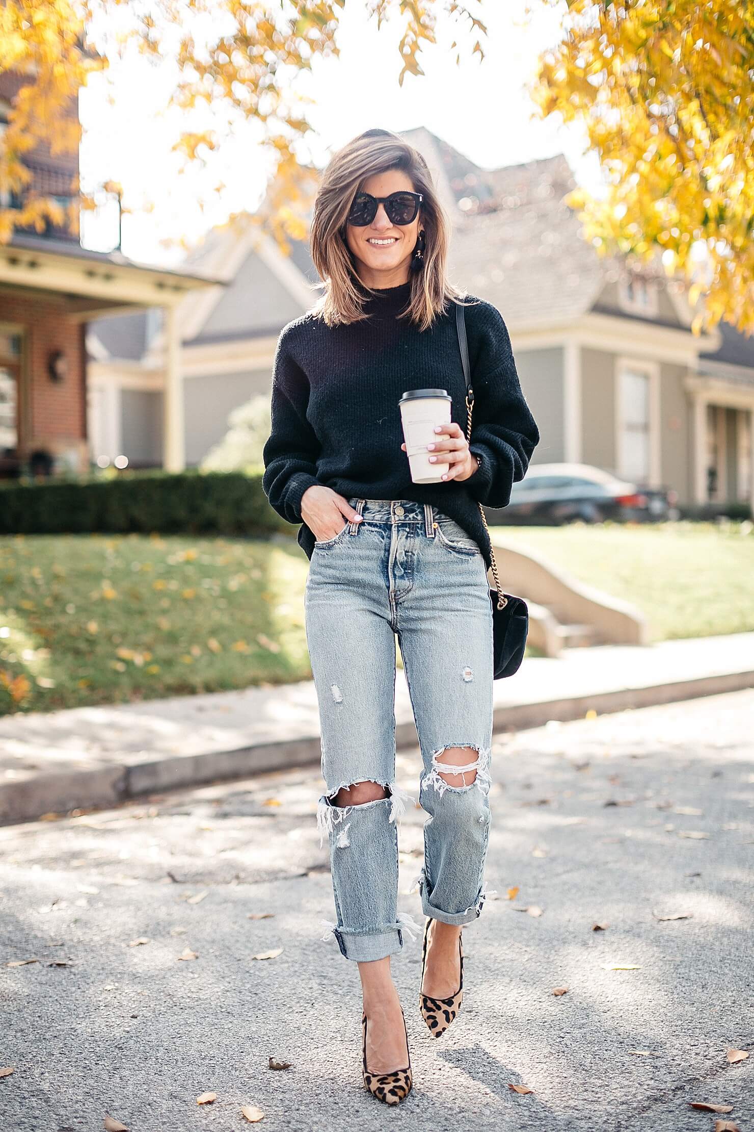 black sweater, distressed levi jeans, leopard pumps and gucci cross body 