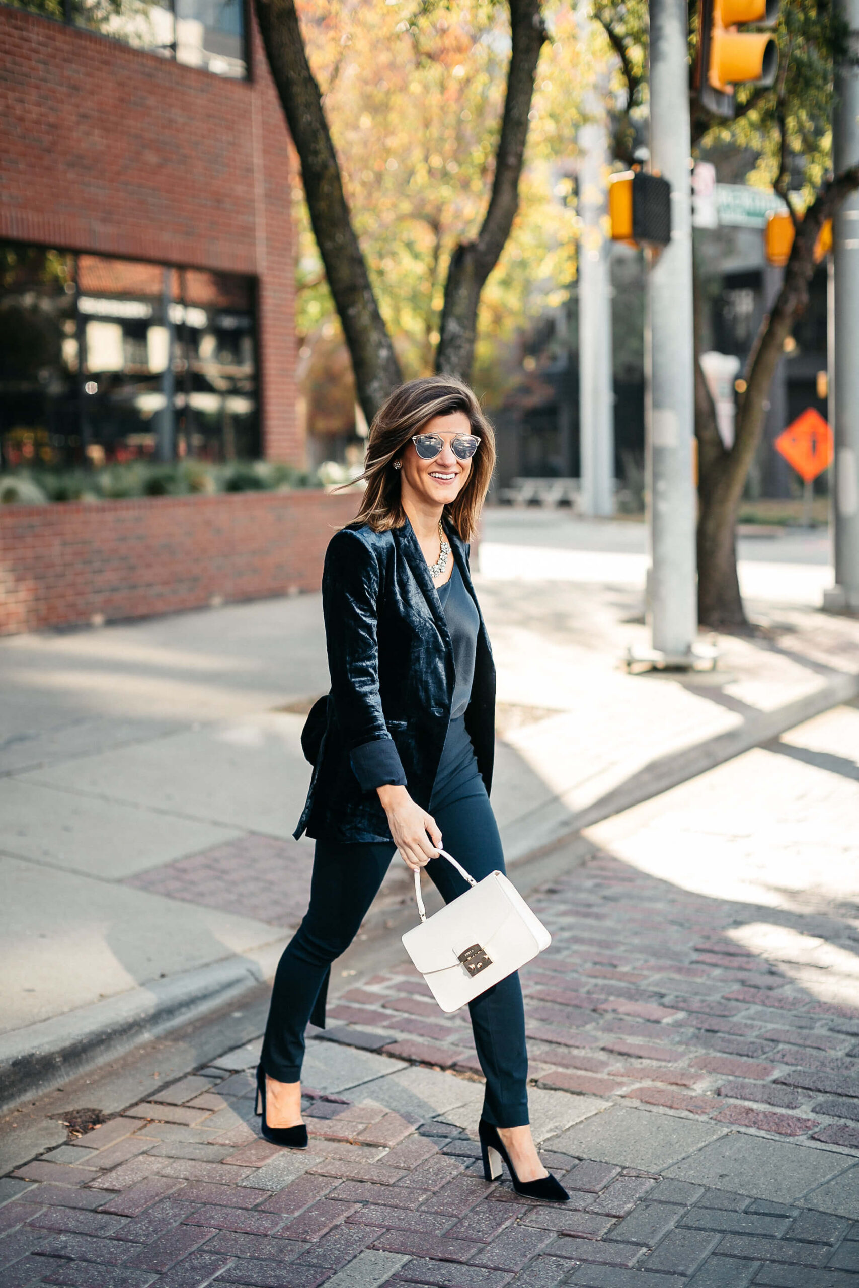 Navy jacket, camisole, blue simone pants, blue velvet pumps, and statement jewelry, dior sunglasses, white furla bag 