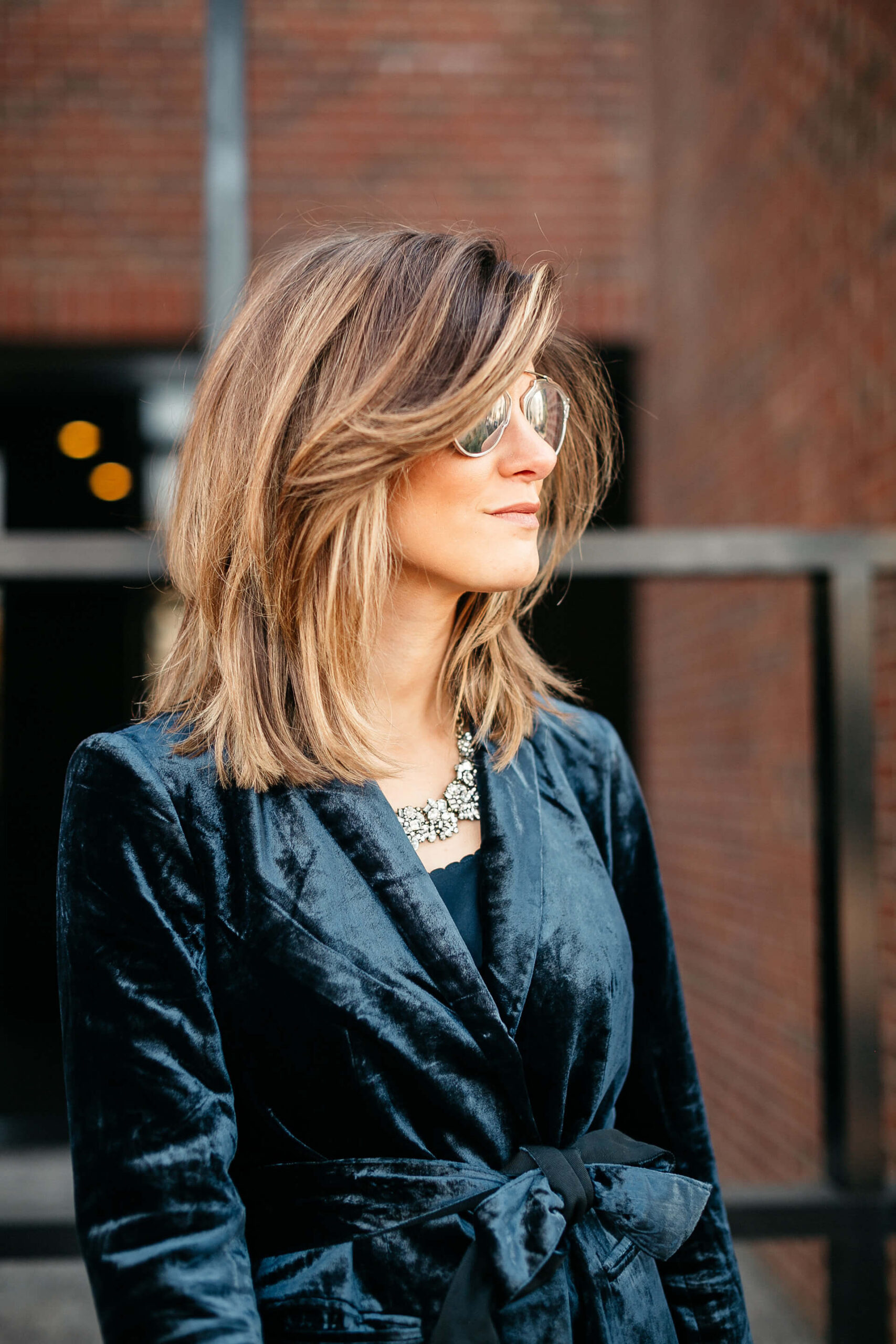 Navy jacket, camisole, blue simone pants, blue velvet pumps, and statement jewelry, dior sunglasses, white furla bag 