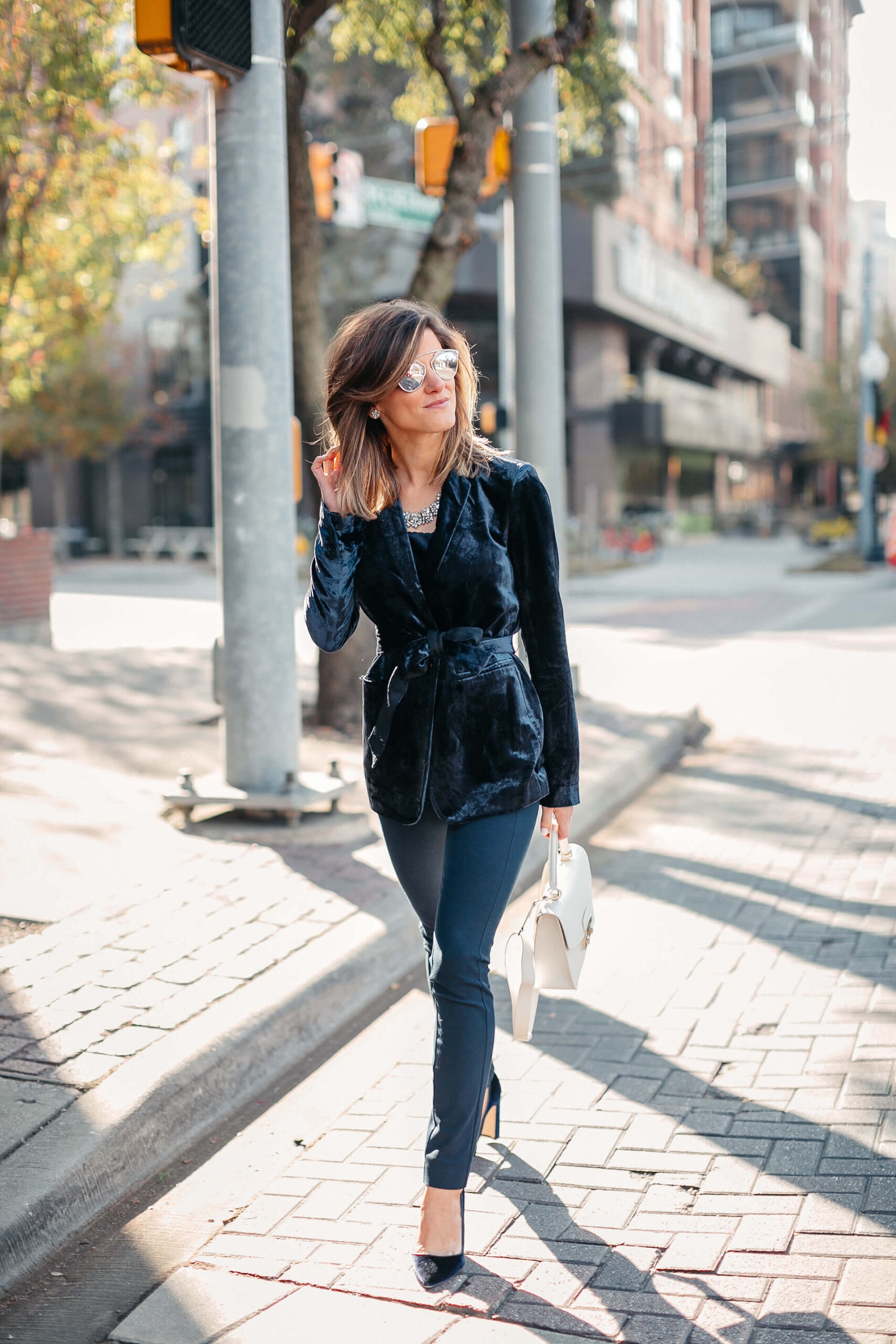 Navy jacket, camisole, blue simone pants, blue velvet pumps, and statement jewelry, dior sunglasses, white furla bag 