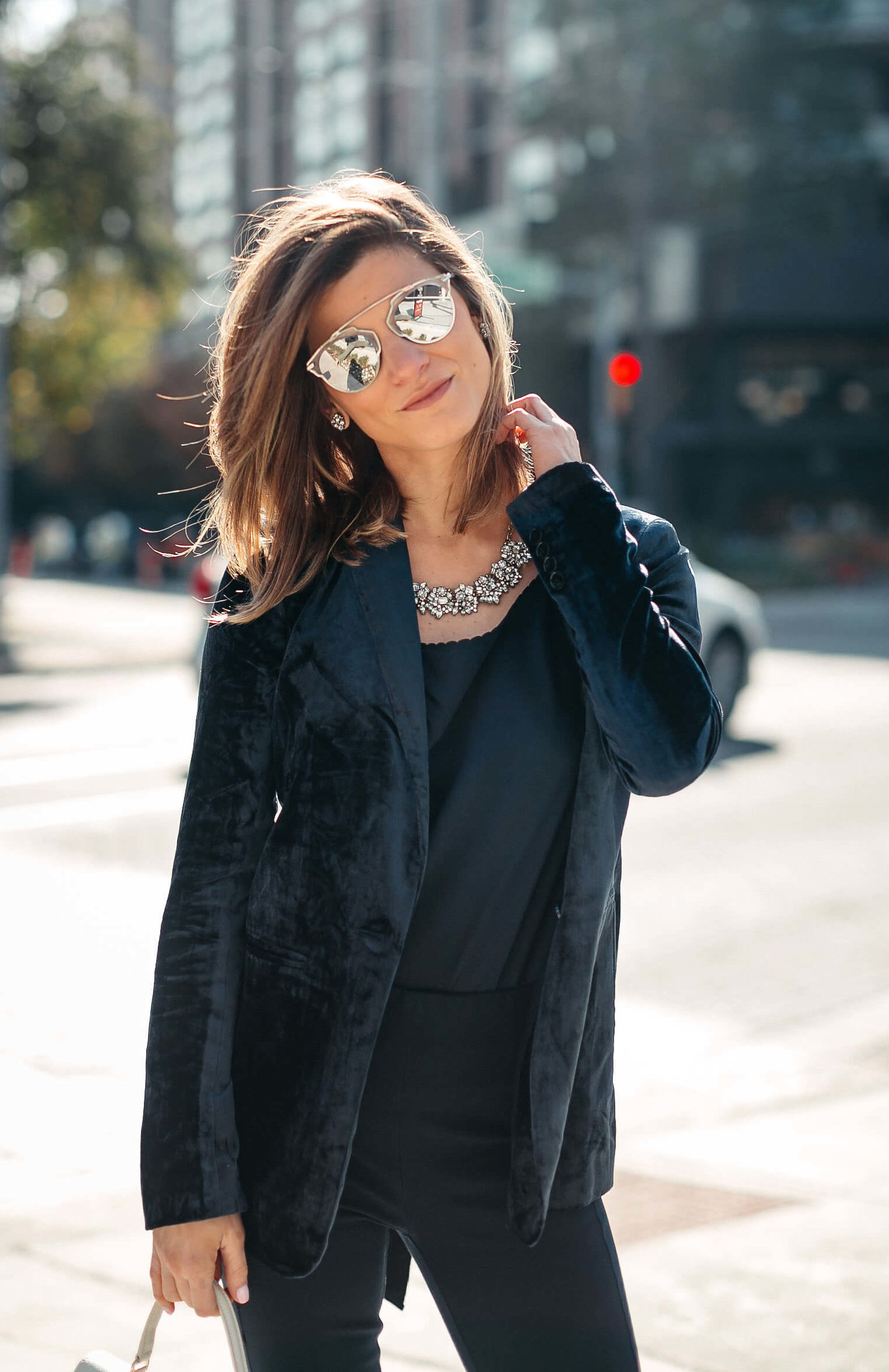 Navy jacket, camisole, blue simone pants, blue velvet pumps, and statement jewelry, dior sunglasses, white furla bag 