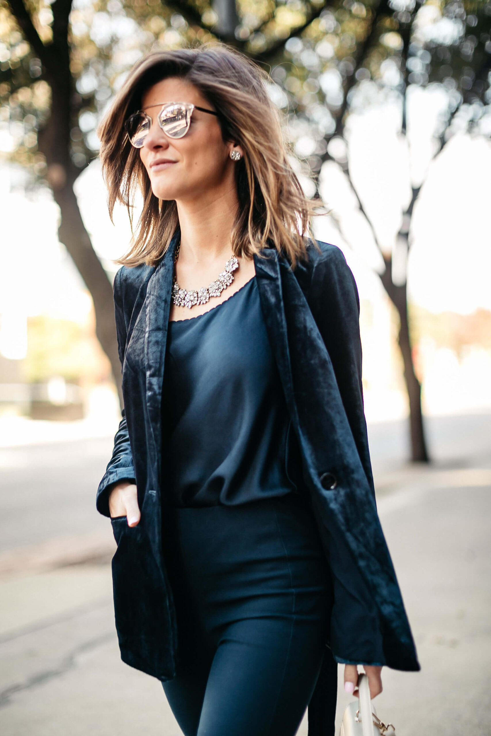 Navy jacket, camisole, blue simone pants, blue velvet pumps, and statement jewelry, dior sunglasses, white furla bag 