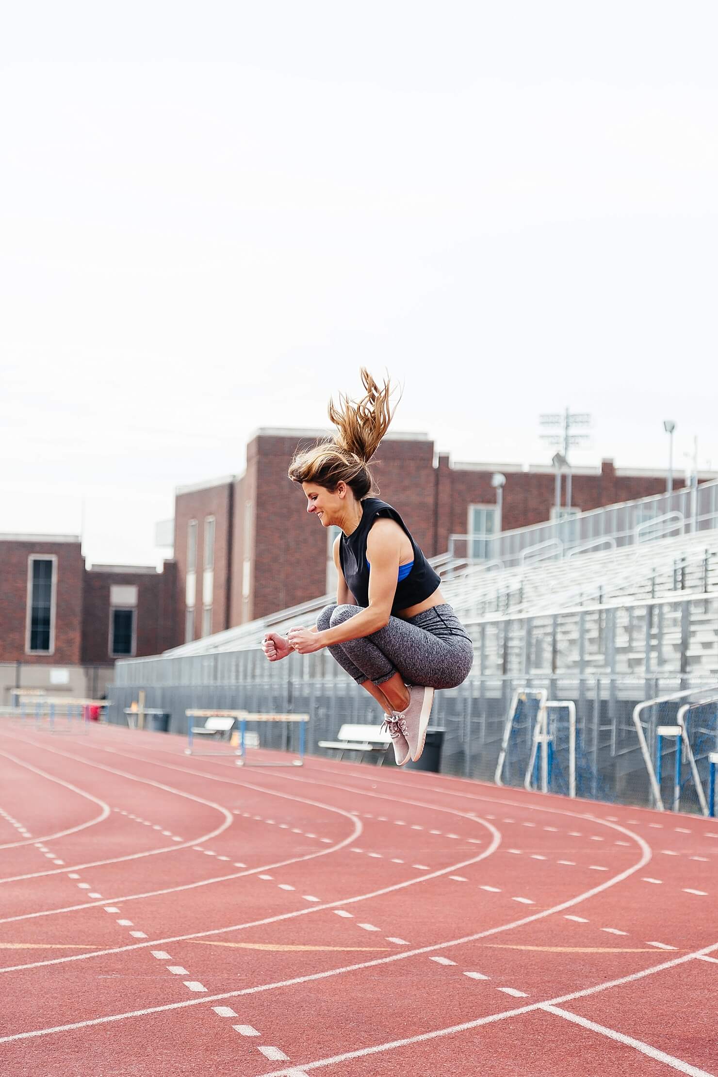 tuck jump lululemon crop leggings and tank with blue sports bra