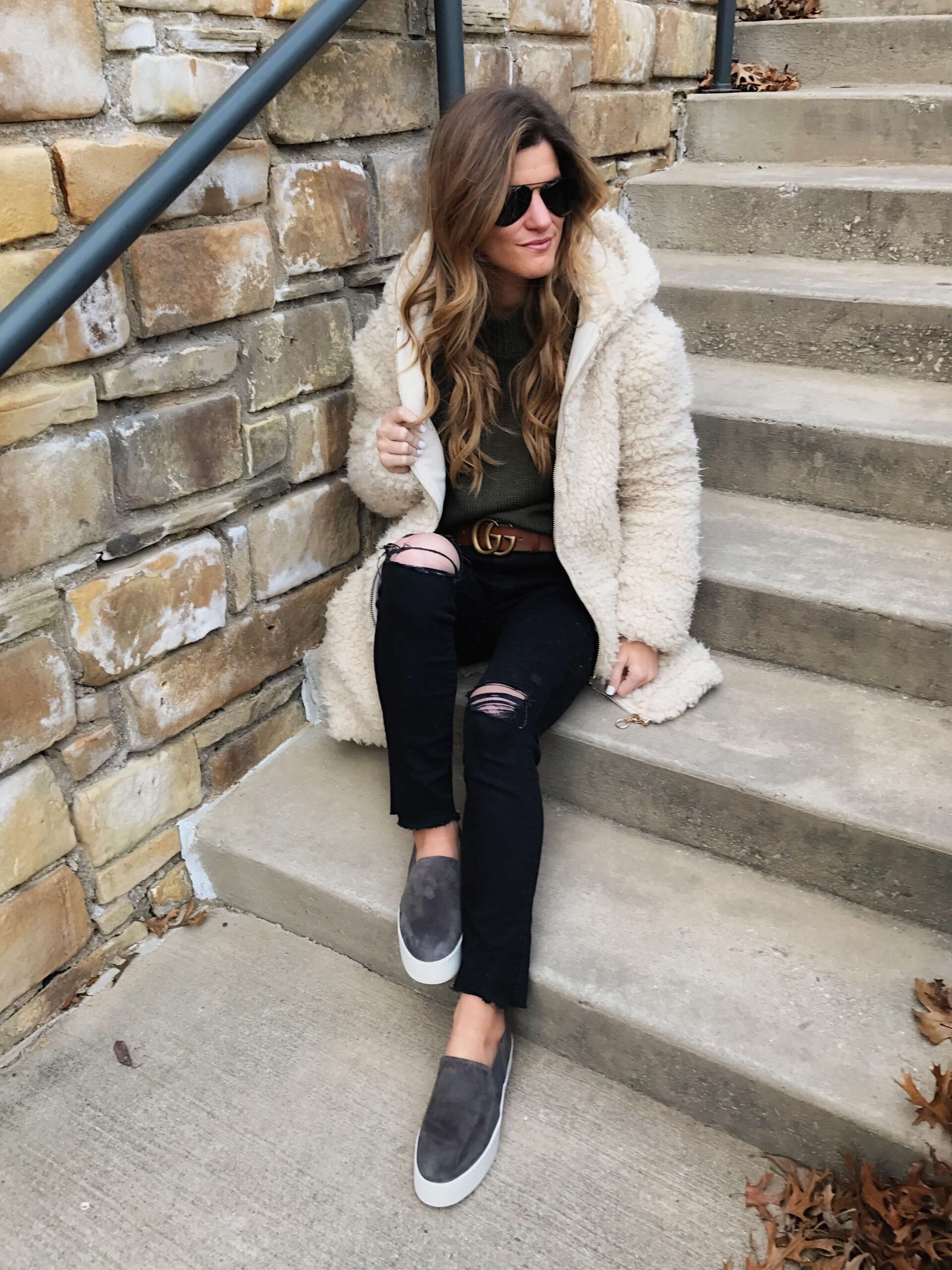 cozy teddy shearling coat, distressed black denim, black jeans and green sweater, vince warren sneakers, aviators, grey suede slip ons